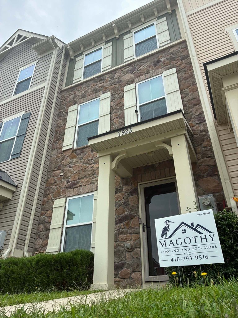 Magothy Roofing and Exteriors yard sign displayed at a completed job site, MHIC 168897