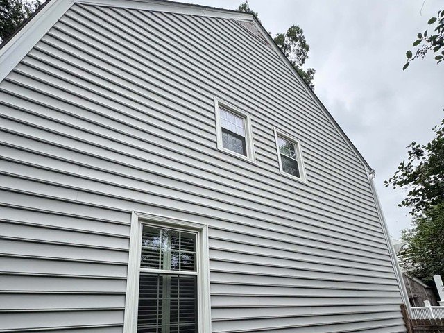 Wide view of the completed siding gable from the side of the home